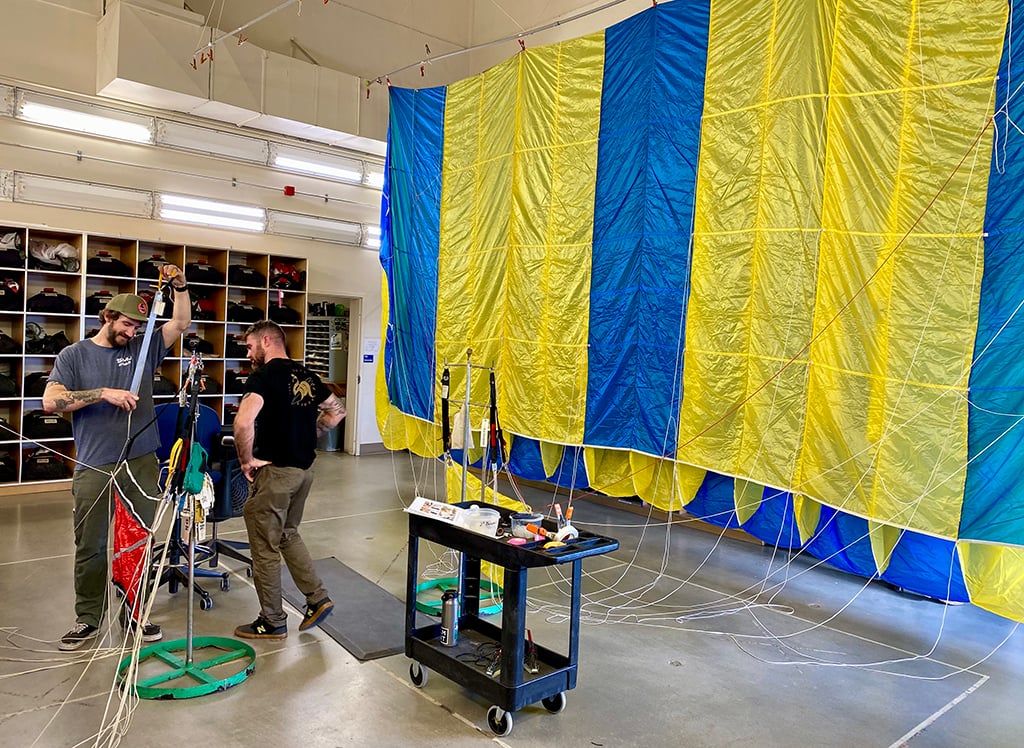 Wildland firefighters inspect parachute