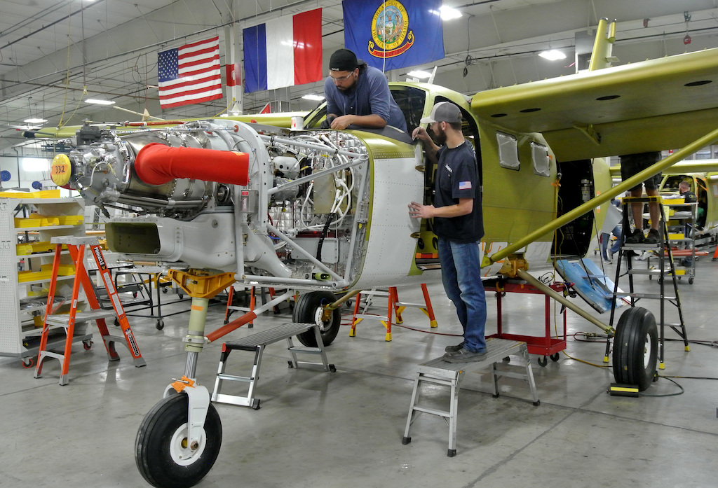 The American, French and Idaho state flag hang from the rafters at the Daher Kodiak final assembly facility in Sandpoint, Idaho