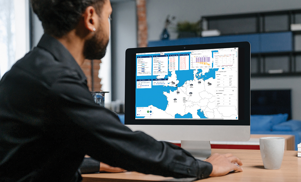 Operator at computer monitor showing AI financial modeling