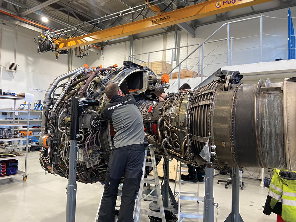 Magnetic MRO technicians working on engine in shop