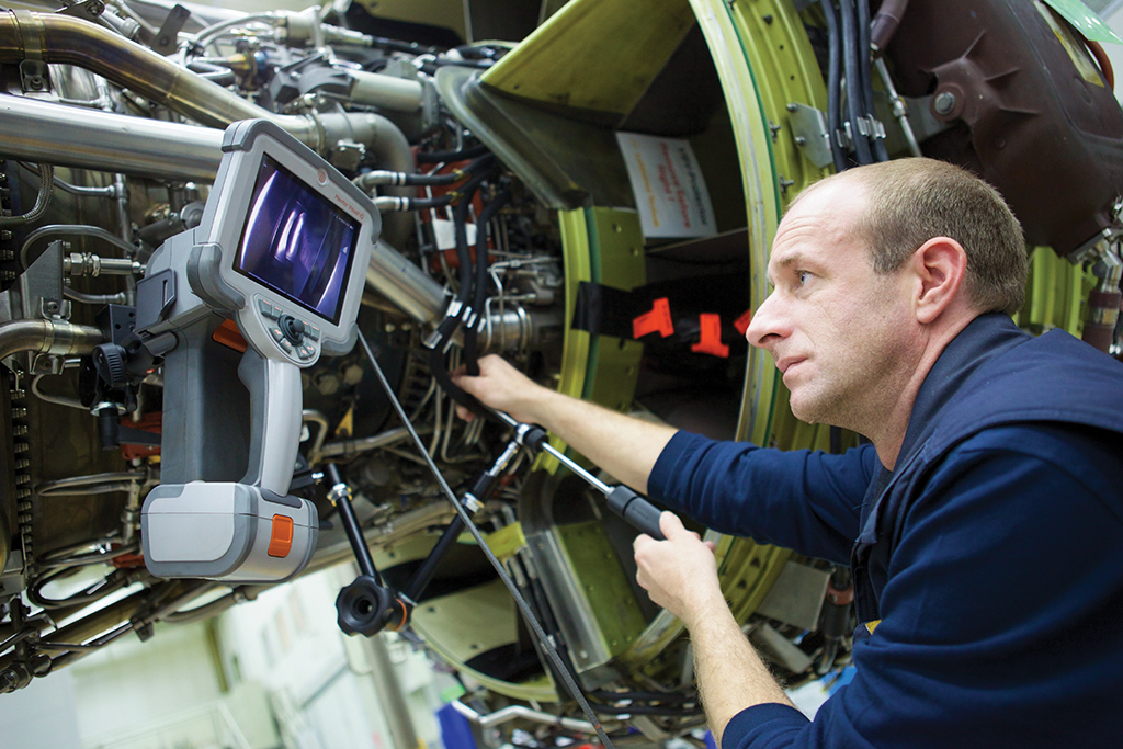 Maintenance technician working on engine