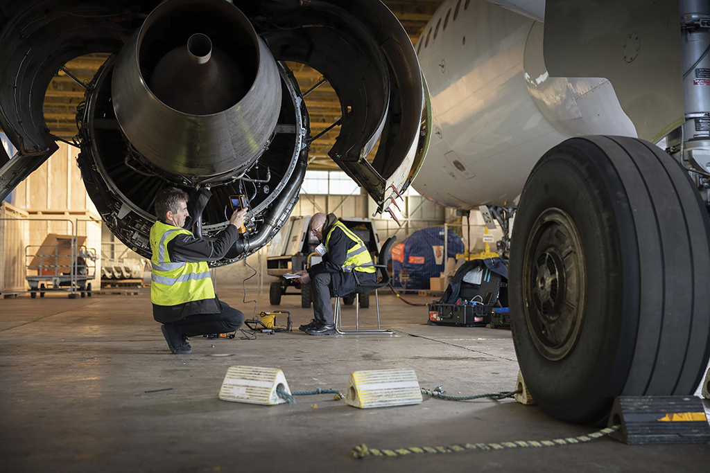 technician working on an aircraft engine