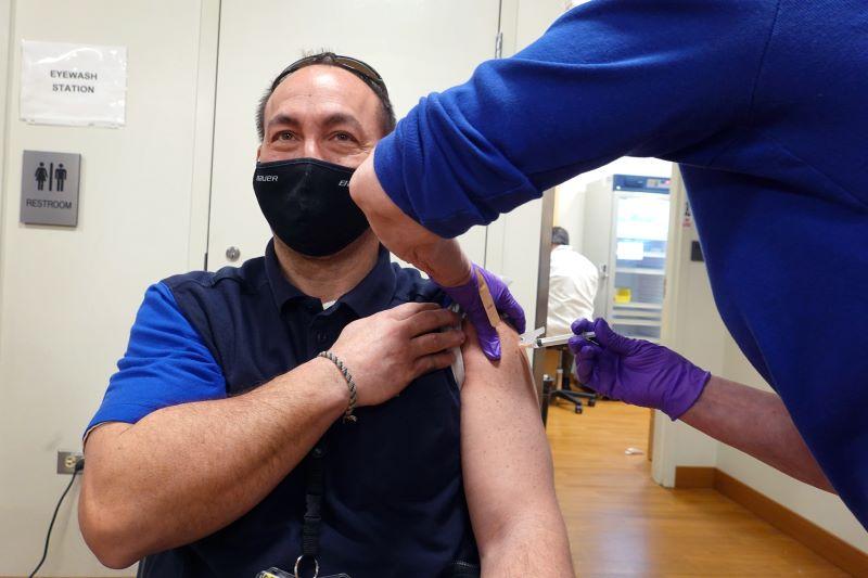 United Airlines ramp services worker receives COVID-19 vaccine