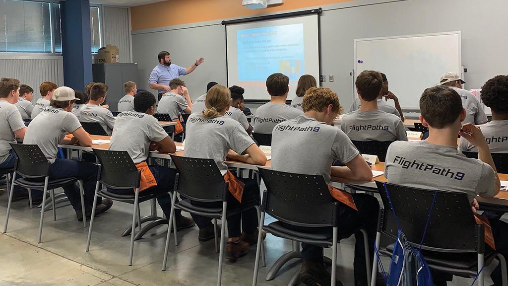 high school students studying aviation