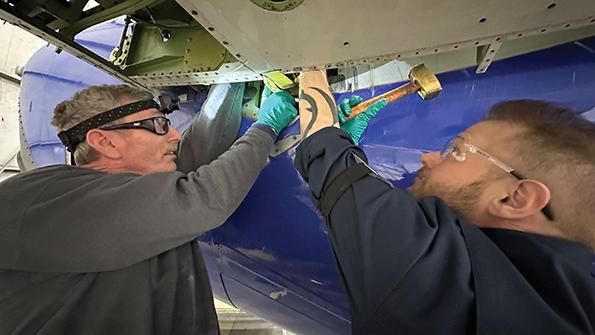 mechanics working on aircraft