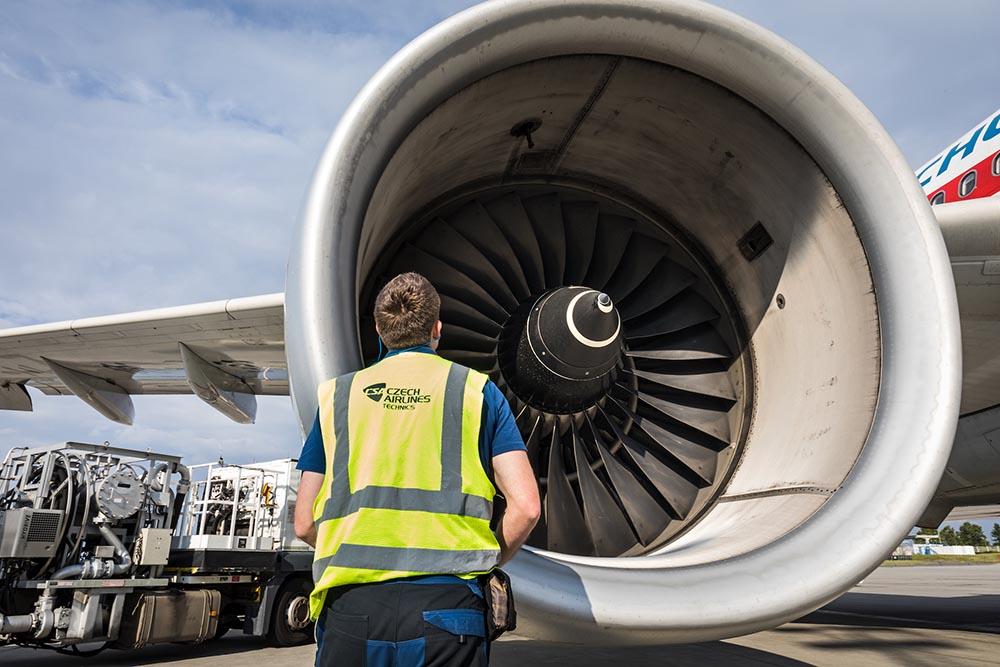 Technician in front of engine