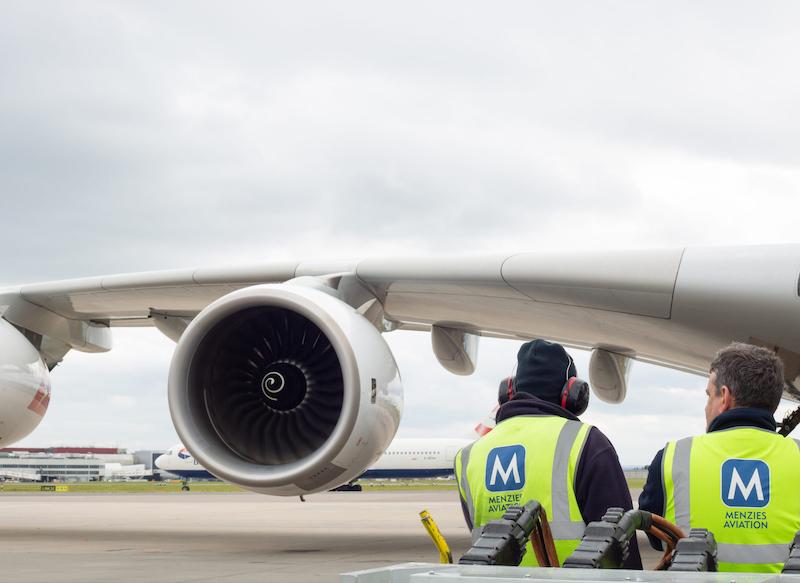 Menzies Aviation workers near plane on tarmac