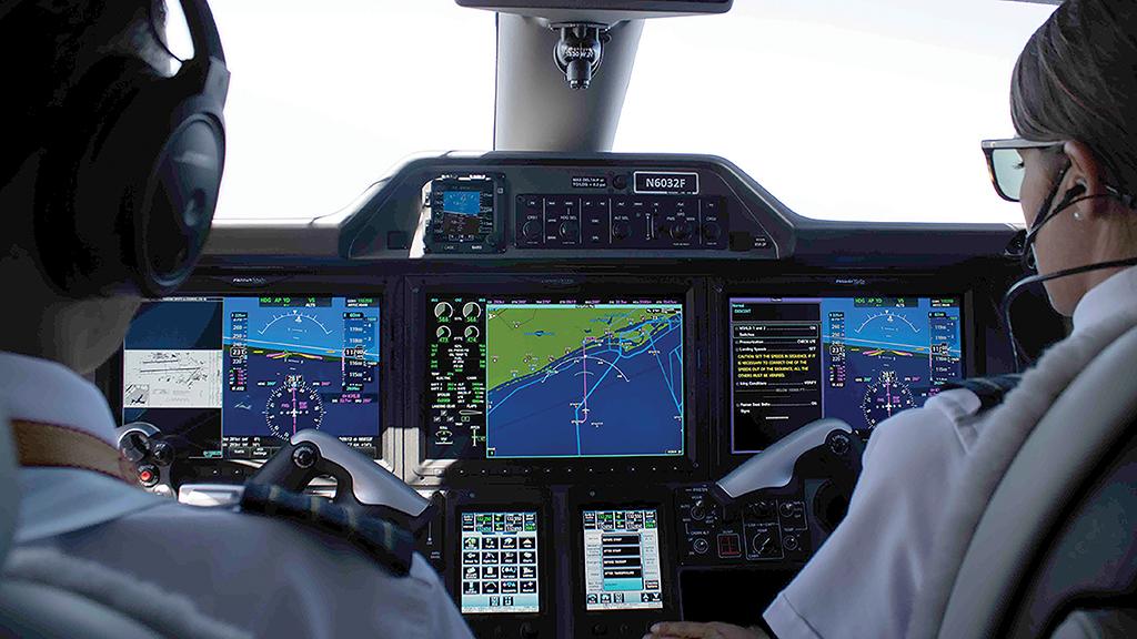 business aviation pilots in Phenom 100E cockpit