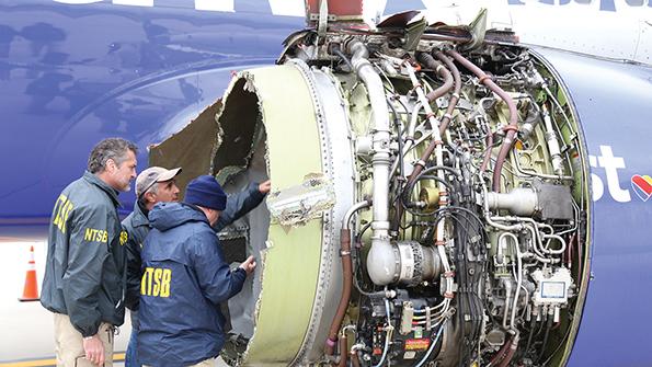 NTSB investigators look at damaged engine