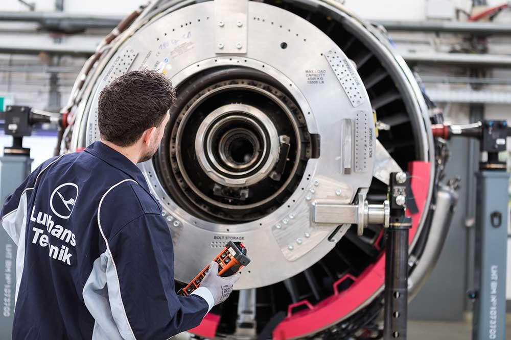 Technician performing engine maintenance