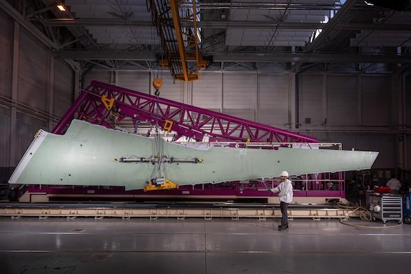 technician with a dassault aviation aircraft wing in production