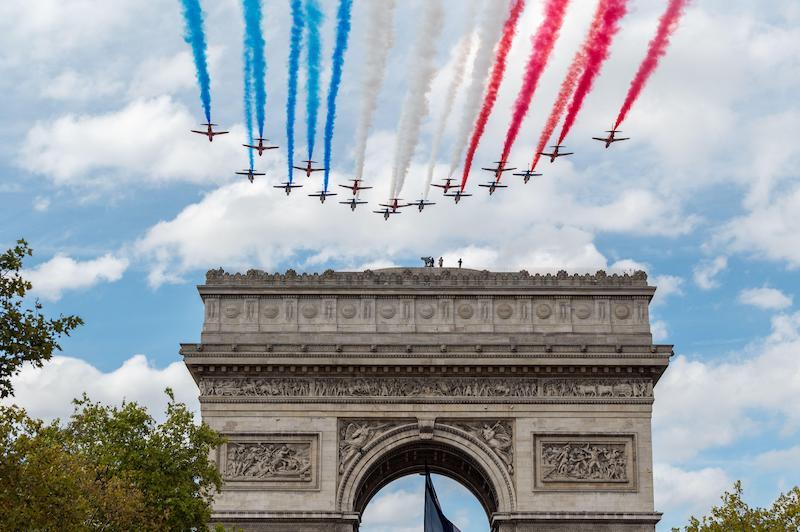 Acrobatic teams create the French flag over Paris