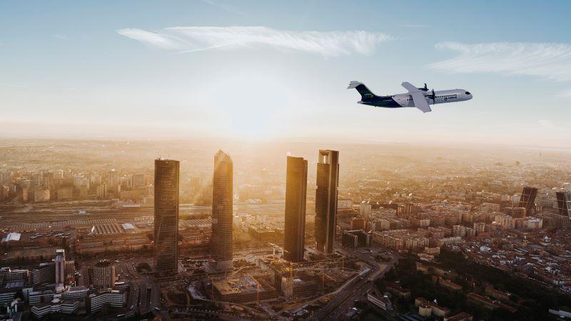 A hydrogen-powered regional aircraft flies over Madrid