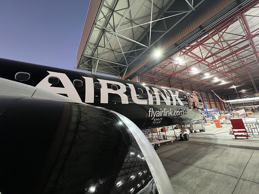 Airlink aircraft nosing into hangar