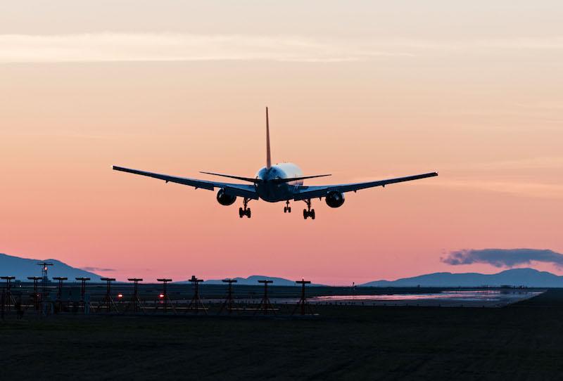 jet flying into sunset