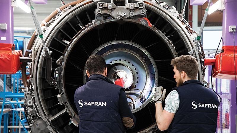 Two Safran employees in front of engine