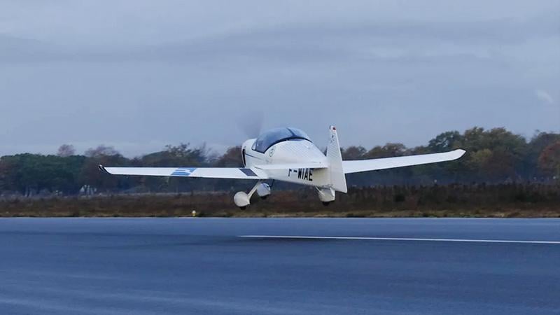 Aura Aero Integral E trainer flies over water