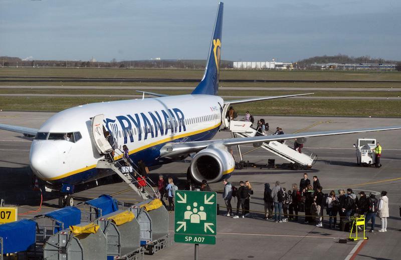 Travelers boarding a Ryanair aircraft at BER Airport