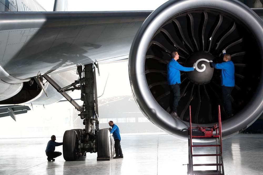 Technicians working on aircraft in hangar