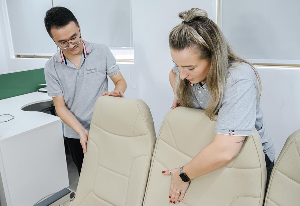 Technicians looking at aircraft seat covers