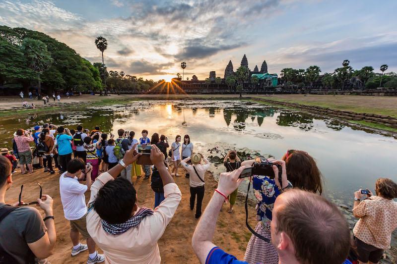 angkor wat with tourists taking photos