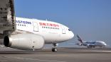 china eastern airlines widebody aircraft foreground on tarmac and emirates airline widebody in background taxiing