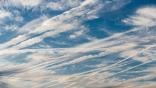 Contrails across daytime sky